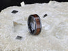 Delphi black titanium black walnut wood ring, worn on hand
