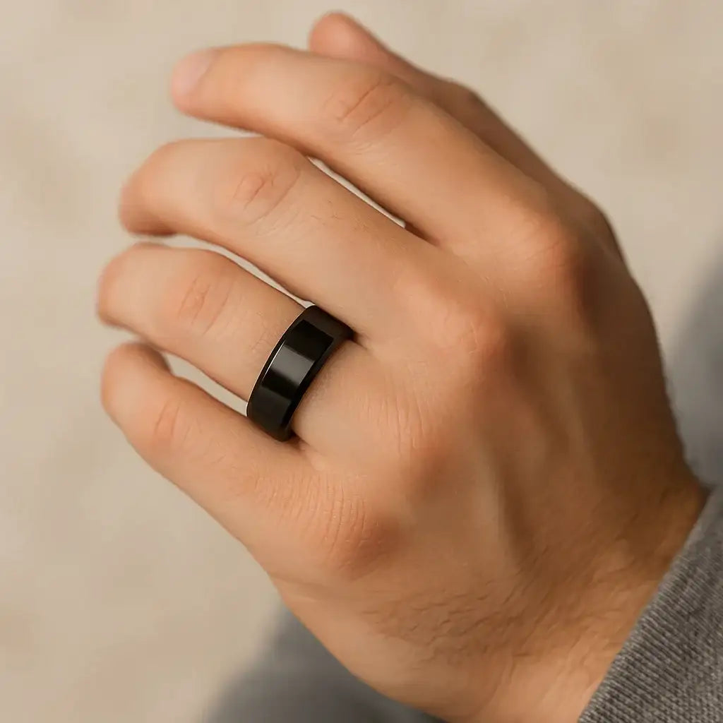 Theseus black titanium ring, worn on hand
